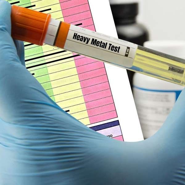 A person is holding a test tube that says heavy metals test for Heavy Metal Challenge Test