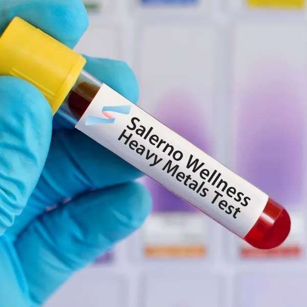 Gloved hand holding a blood vial labeled 