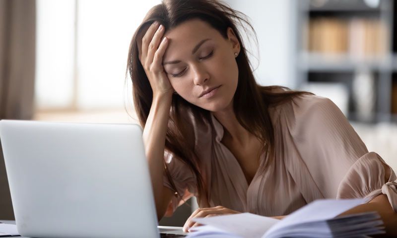 A woman with fatigue from heavy metal toxicity reading How to Remove Heavy Metals with Chelation Therapy