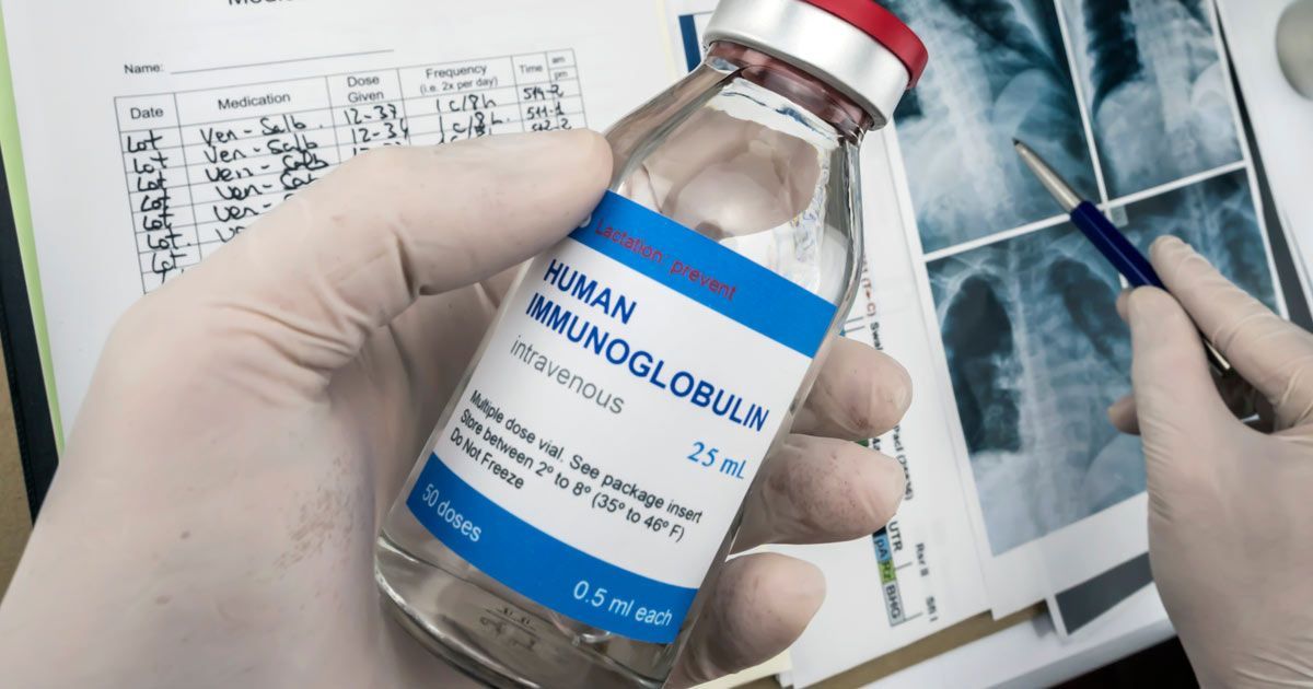 A Doctor holding a bottle of Immunoglobulin IVIG Therapy NYC by Dr. John Salerno