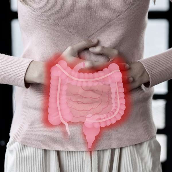 Woman clutching abdomen; red graphic overlay depicts ileaky gut syndrome