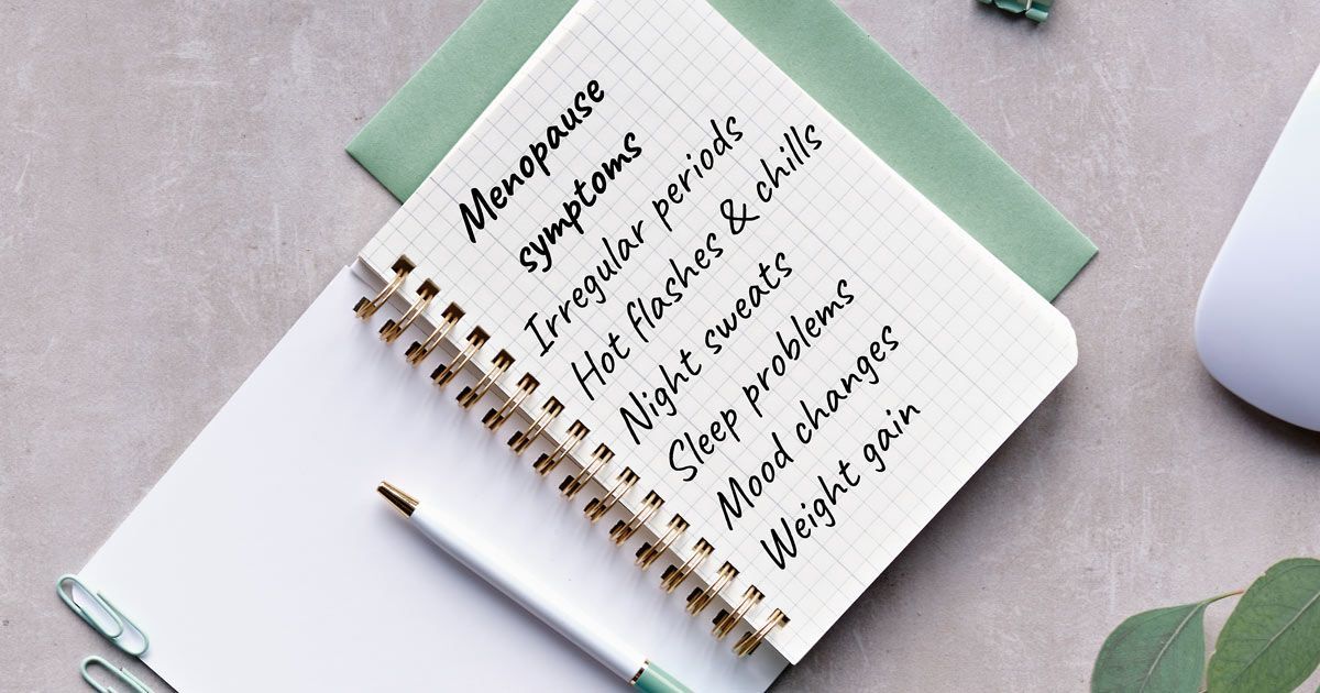 A notebook with a pen and a mouse on a table representing Menopause Treatments NYC - Dr. John Salerno