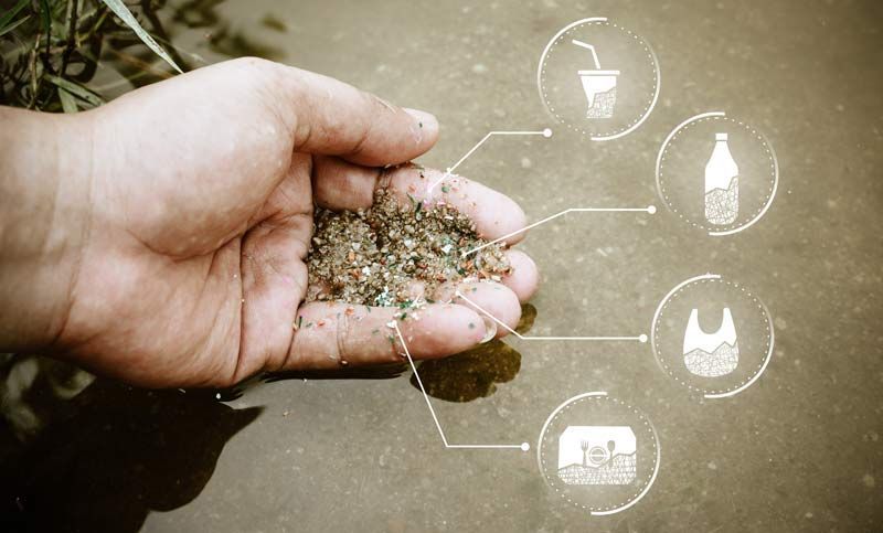 Hand holding microplastics, with icons of plastic items: cup, bottle, bag, and container.