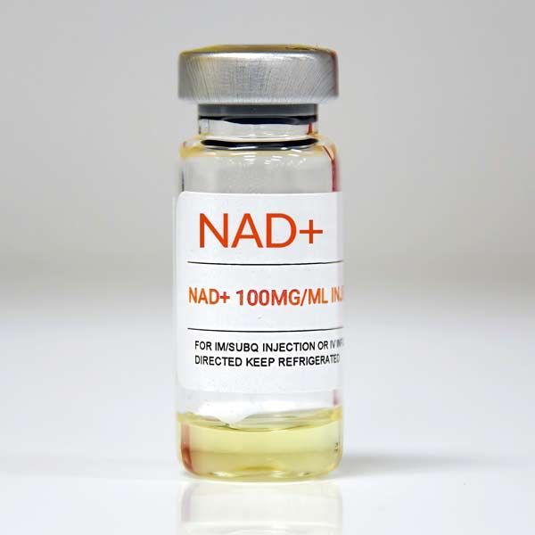 A bottle of NAD+ + 100 mg/ml is sitting on a table representing NAD+ IV Treatments