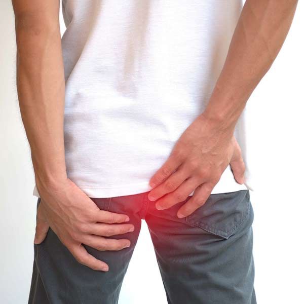 Man holding is butt indicating aneed for Proctitis Treatments