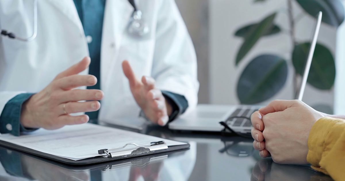 Doctor meeting with a patient, representing Salerno Wellness Reviews and Testimonials for Dr. John Salerno