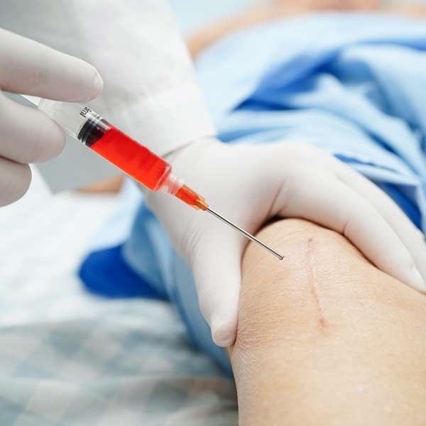 A person is getting an injection in their leg. A Natural Approach to Regenerative, Integrative, and Complementary Medical Treatments in Manhattan, NYC, and Connecticut.