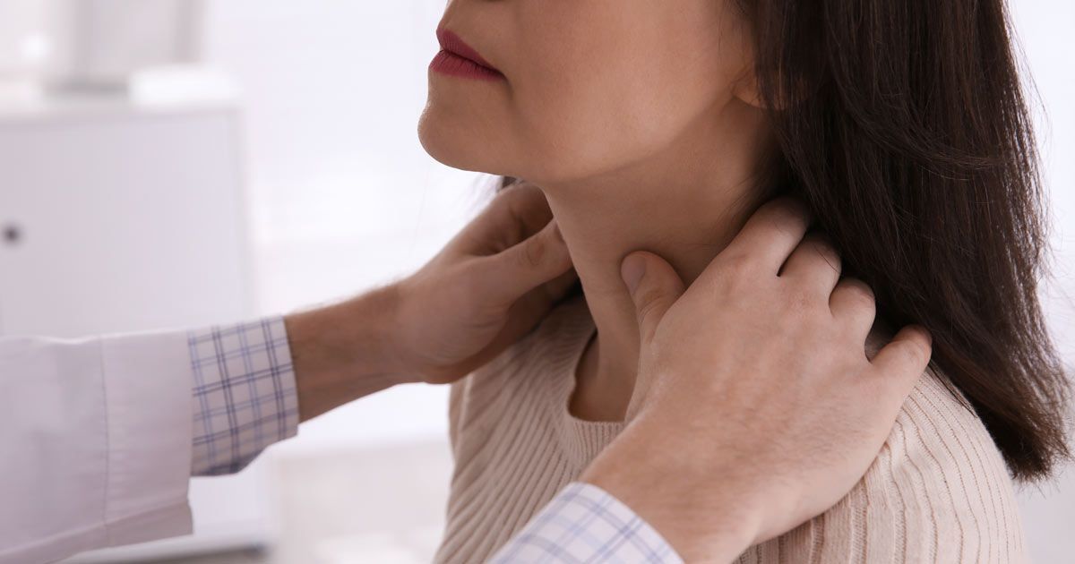 A woman is getting her neck examined by a doctor for Hypothyroidism Treatments NYC by Dr. John Salerno