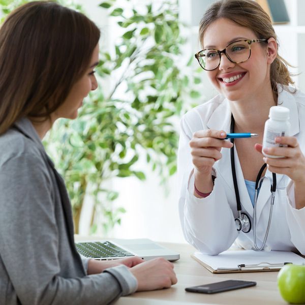 A female doctor is smiling while talking to a patient about Supplements for Weight Loss