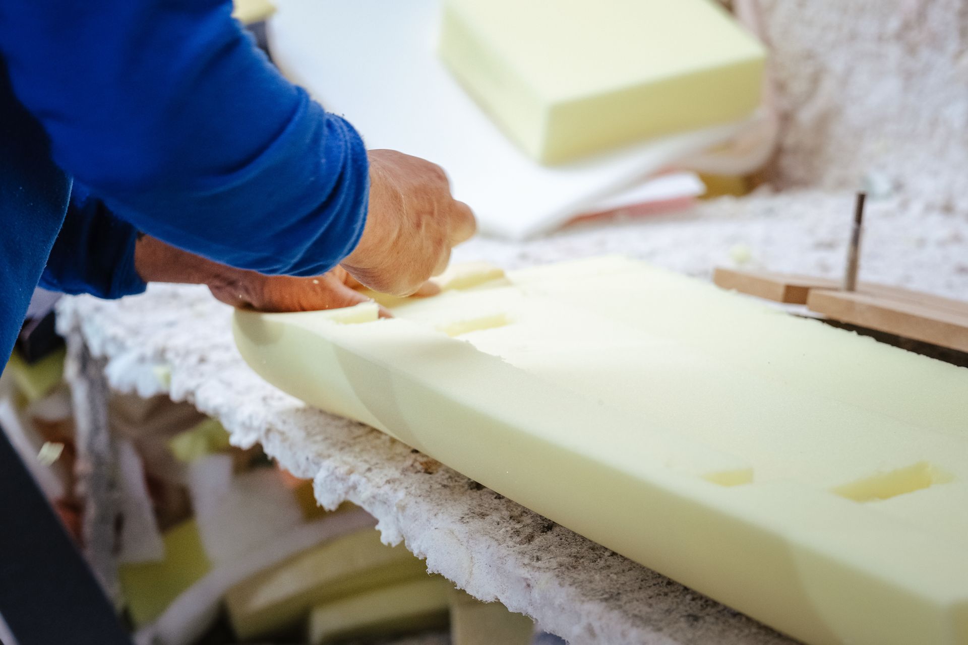 A person is working on a piece of foam on a table.