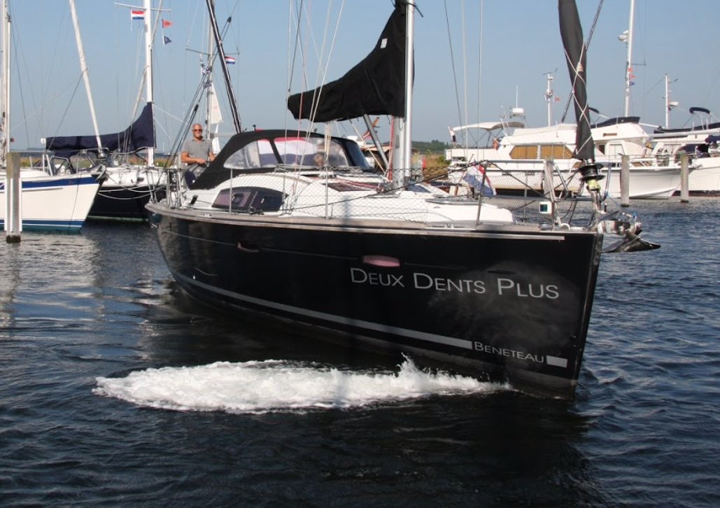 Beneteau sailing yacht with activated Jet Thruster. Water jet visible at the bow section: the boat is turning into the wind