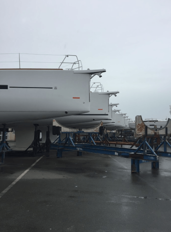 Dufour factory yard with new boats on display, Jet Thruster nozzles visible to the bow of new to be delivered sailing yachts