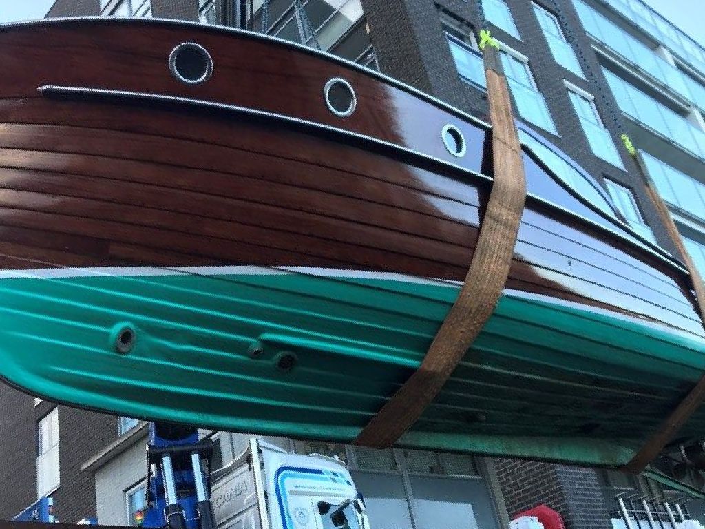 A jet thruster nozzle visible in a wooden boat