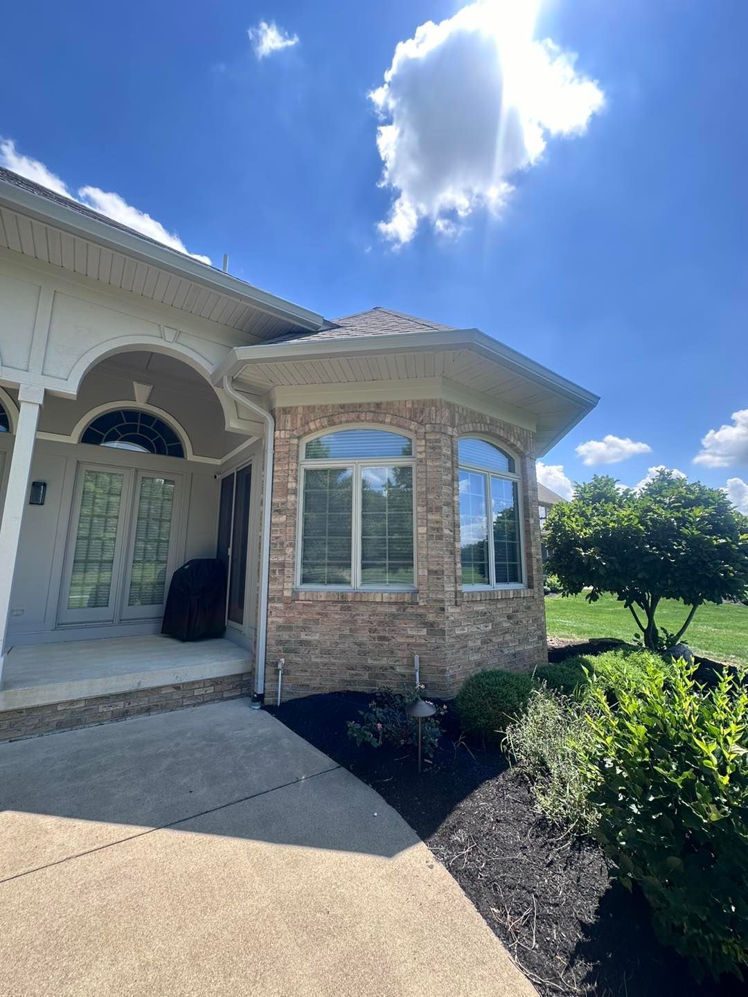 A large house with a lot of windows and a blue sky in the background.