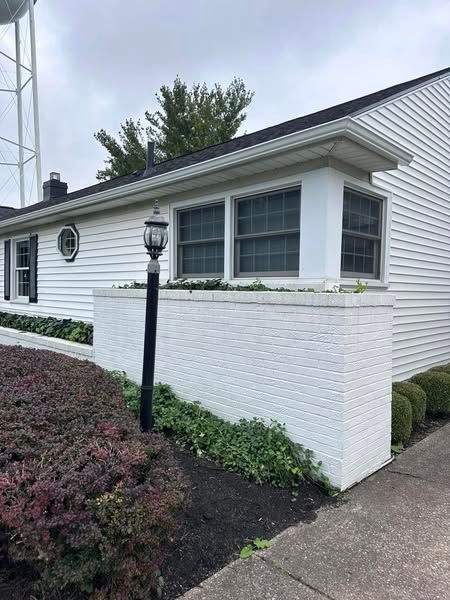 A white house with a water tower in the background.