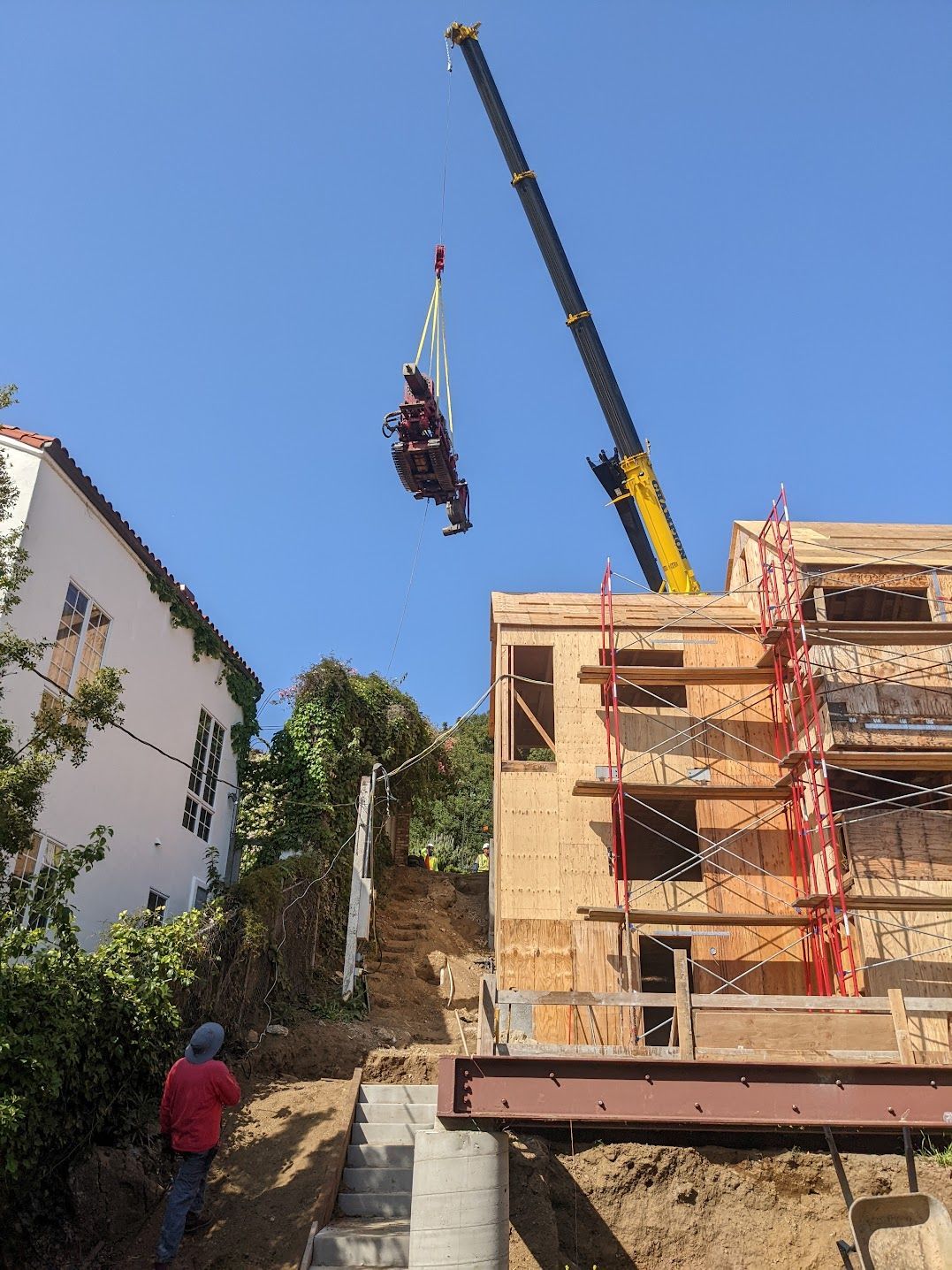 Limited access drilling rig being lifted over house — hollywood , CA — RCW Construction Inc.