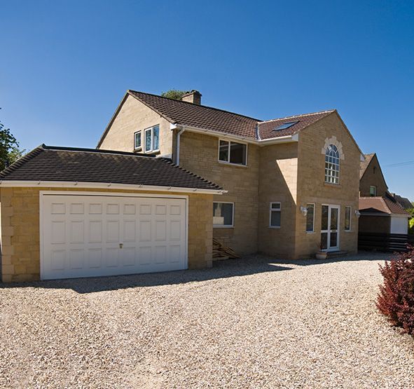 a large brick house with a white garage door