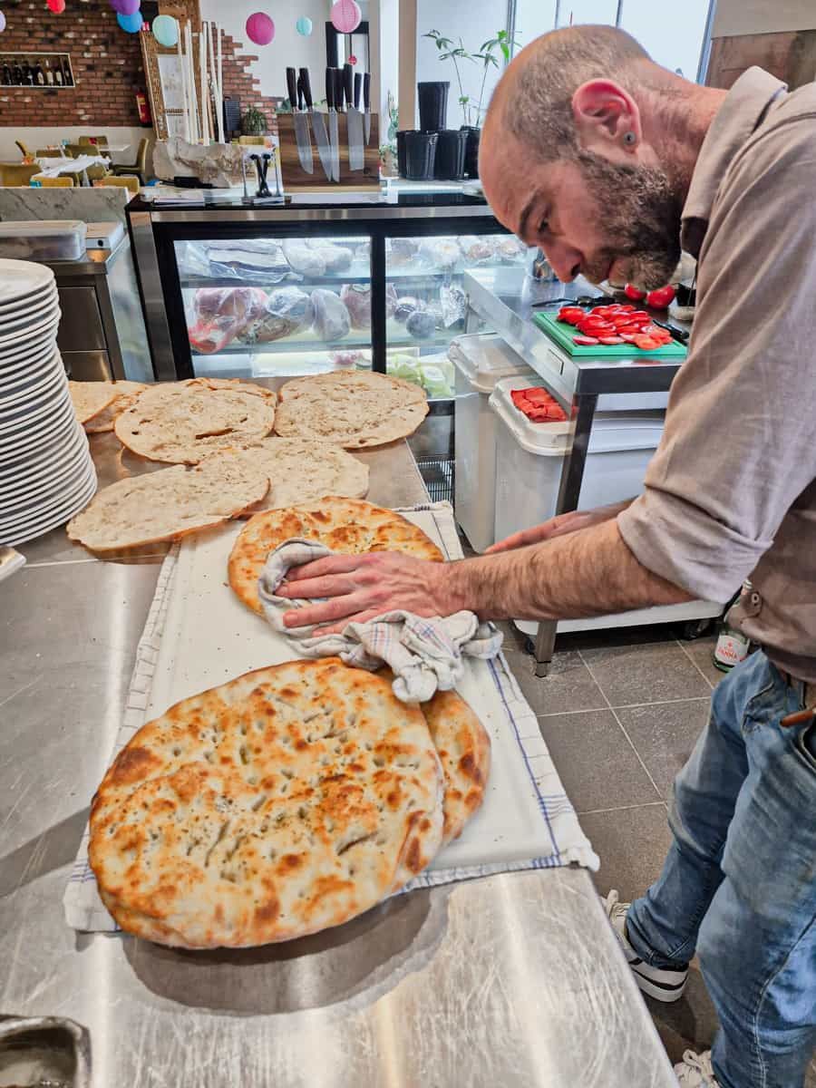 Chef slicing focaccia bread