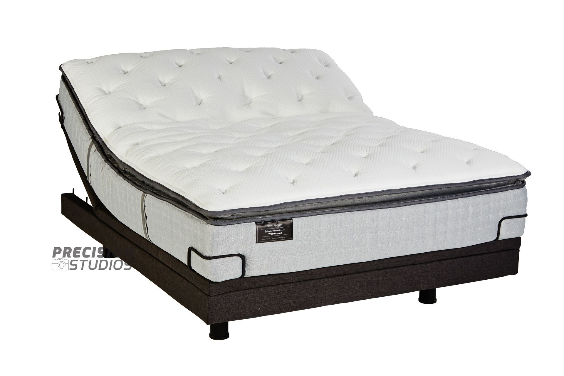 An adjustable bed with a mattress on top of it