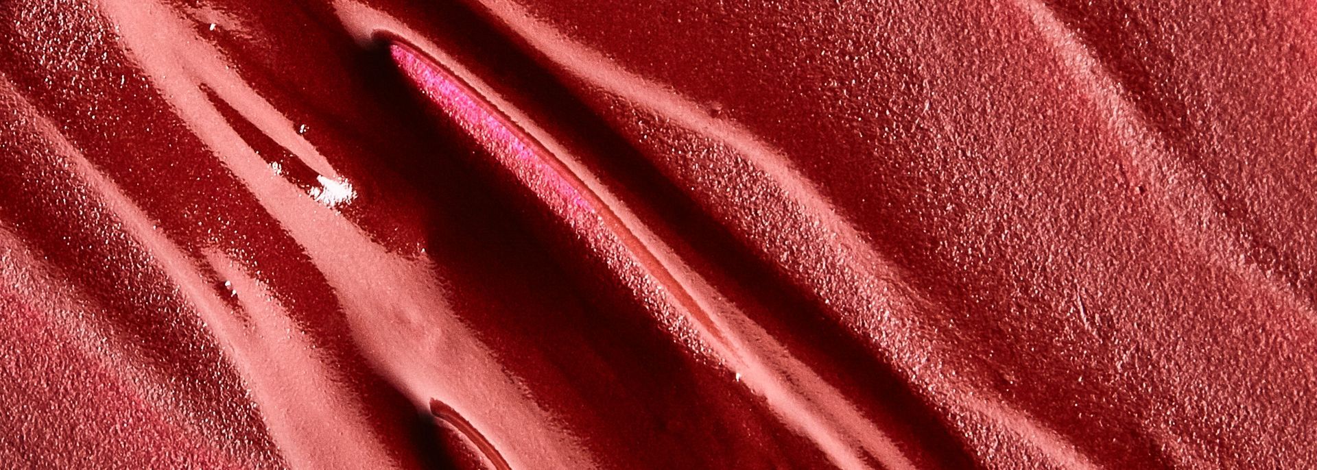 A close up of a red velvet makeup with a diamond in the middle.