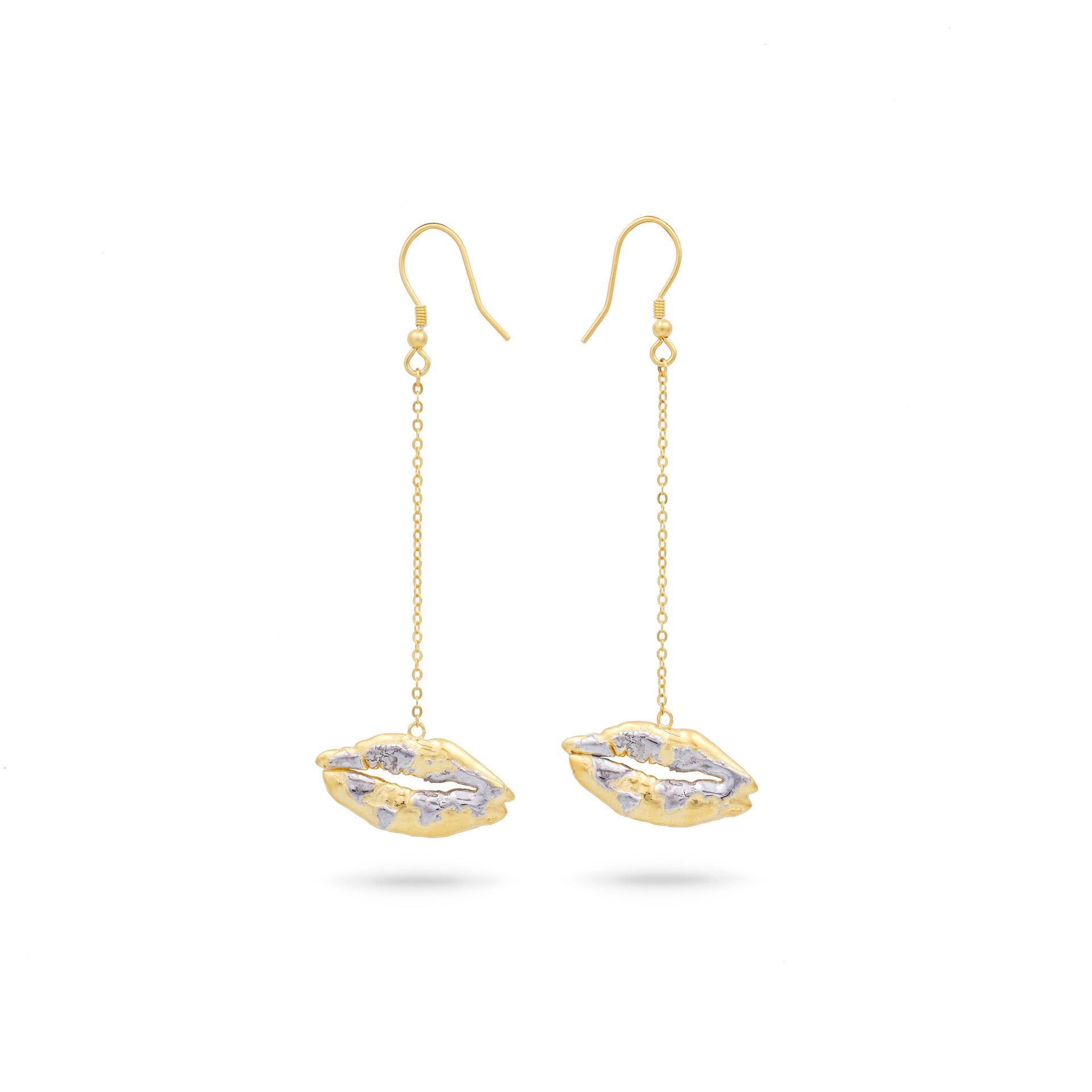 A pair of gold earrings with a kiss on them