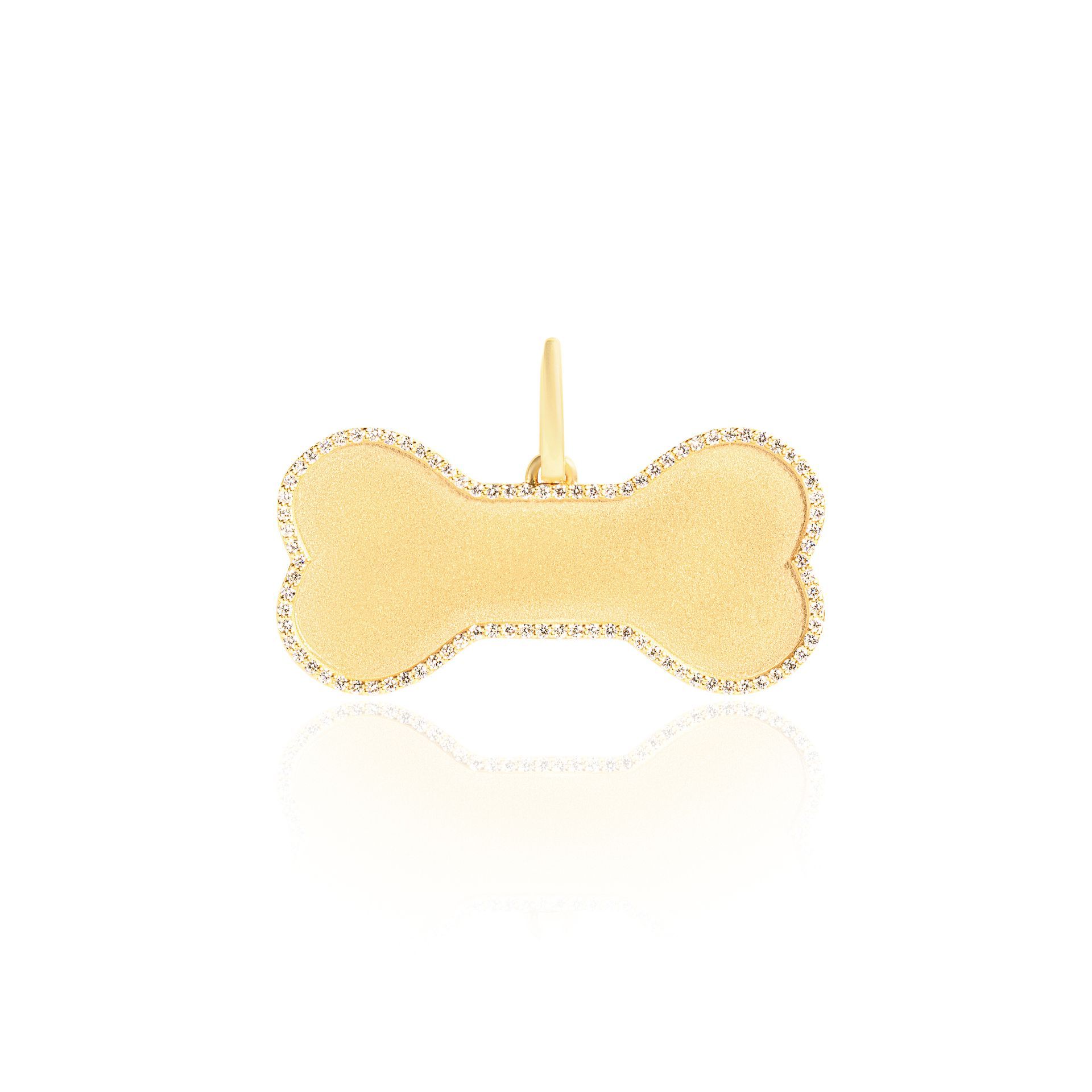 A gold bone shaped pendant on a white background