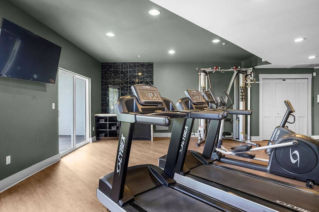 Interior of a resident gym with treadmills and exercise machines.