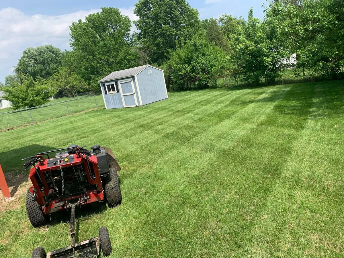 Lawn Mower in the Middle of a Lush Green Field — Saint Louis, MO — Zerr Lawn Care & Landscape LLC