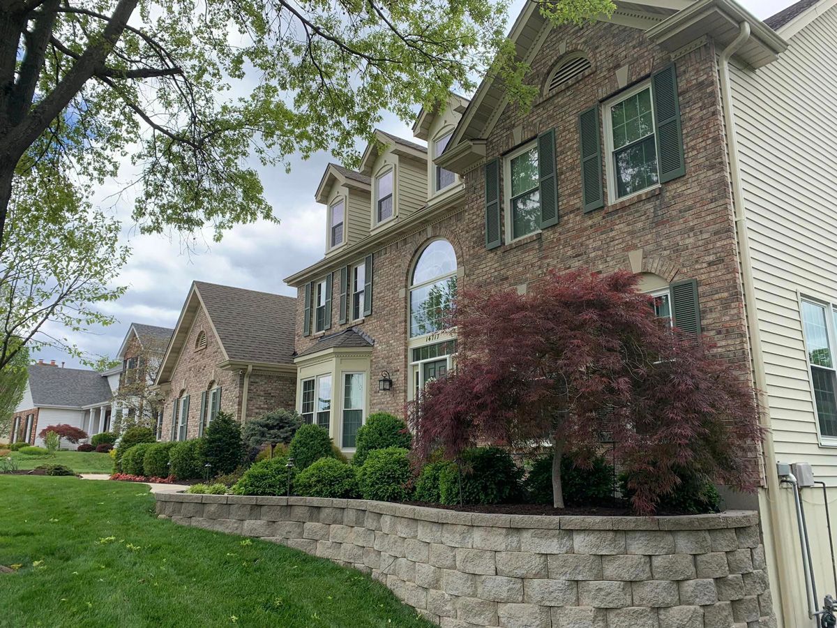 Large Brick House with a Stone Wall — Saint Louis, MO — Zerr Lawn Care & Landscape LLC