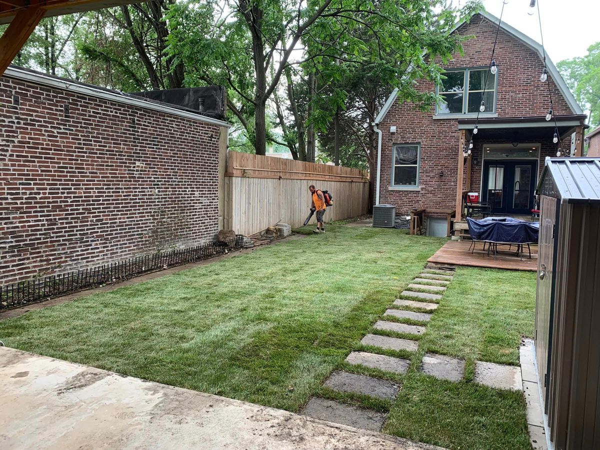 Man Mowing the Grass in the Backyard — Saint Louis, MO — Zerr Lawn Care & Landscape LLC