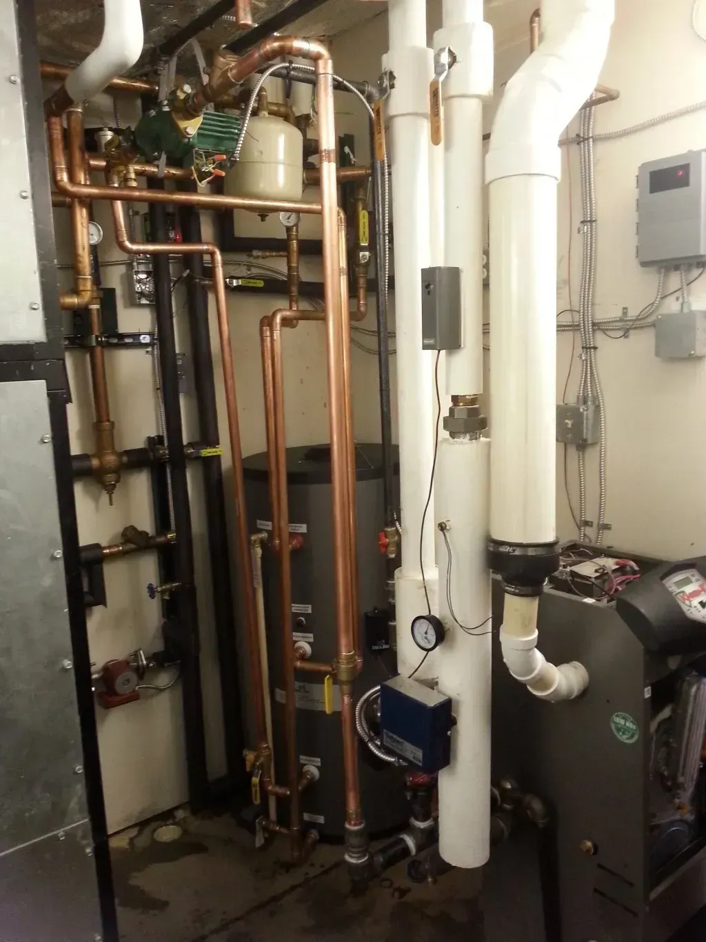 A room filled with copper pipes and white pipes
