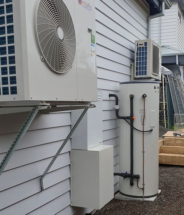 An Heat Pump and A Water Heater on The Side of A Building — Sunworks Eco Plumbing In Torquay, VIC