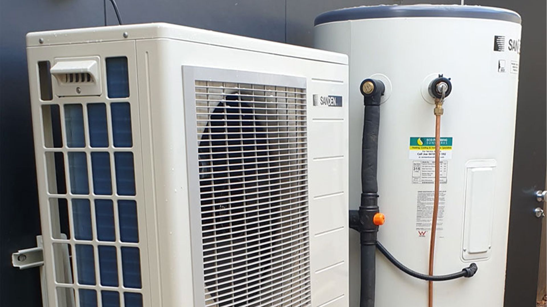 A Heat Pump and A Water Heater Are Sitting Next to Each Other — Sunworks Eco Plumbing In Torquay, VIC