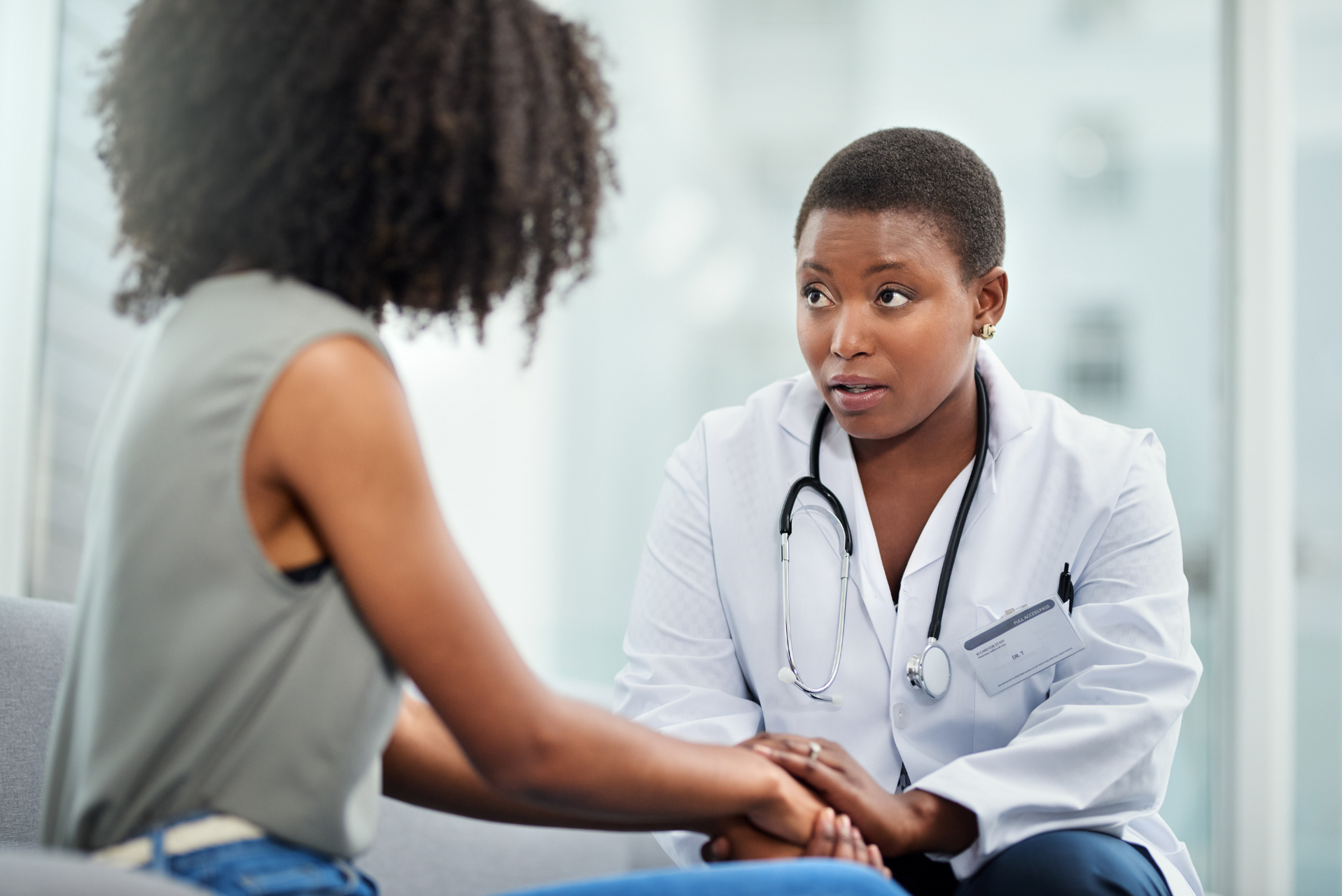 A woman taking the first step to cancer prevention by talking to their primary care physician.