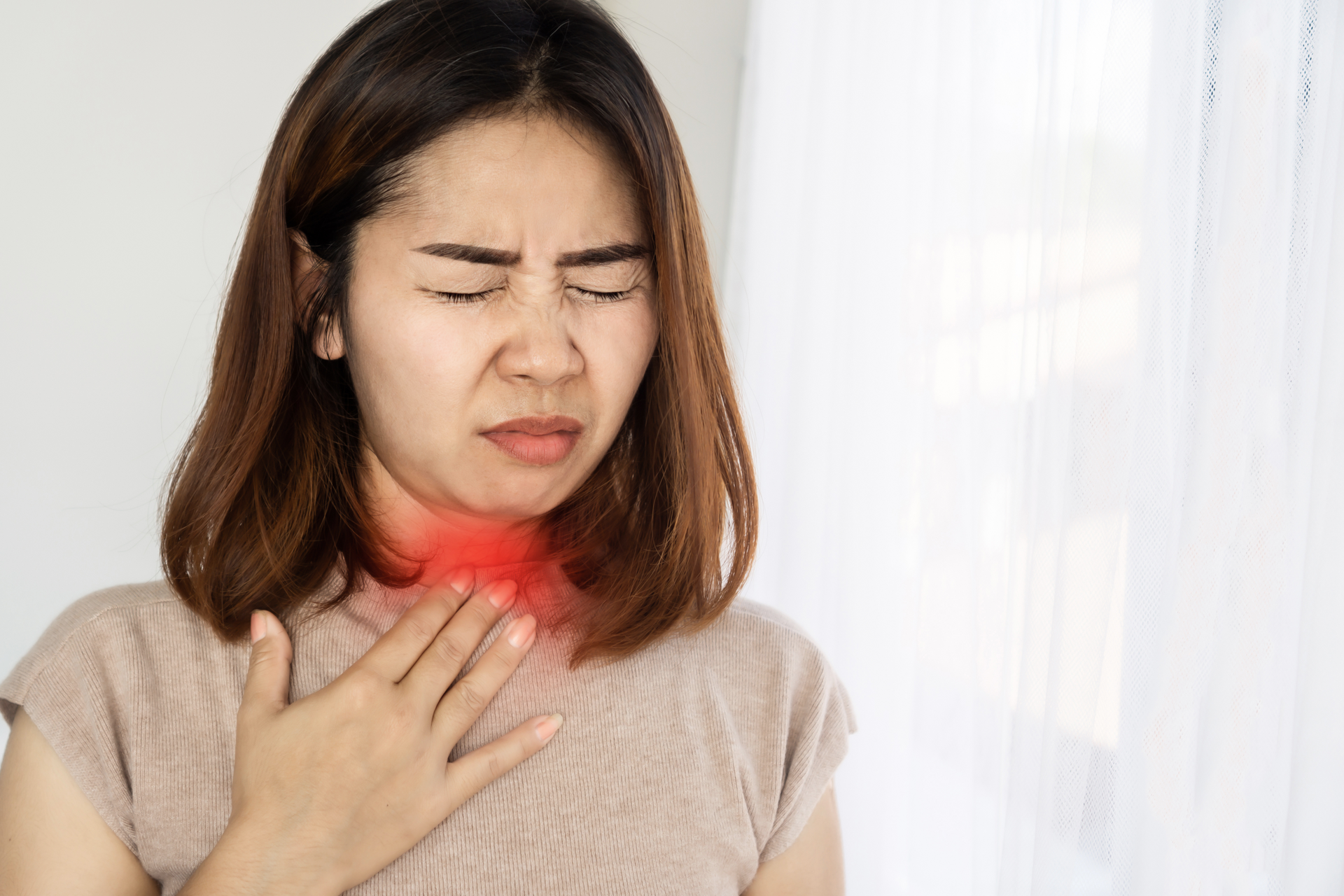 A woman feeling discomfort and irritation due to strep throat