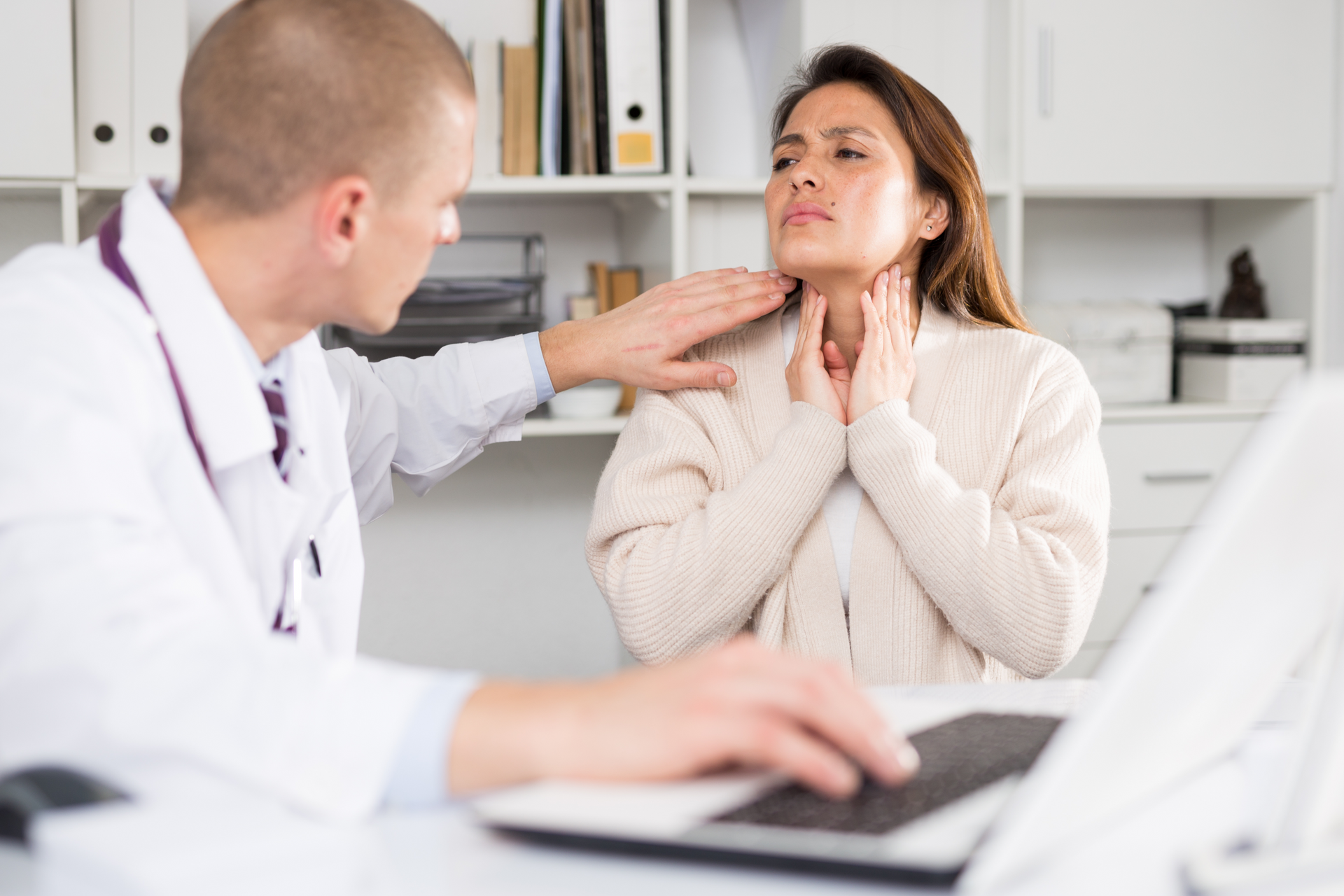 A healthcare professional checking on a woman’s strep throat