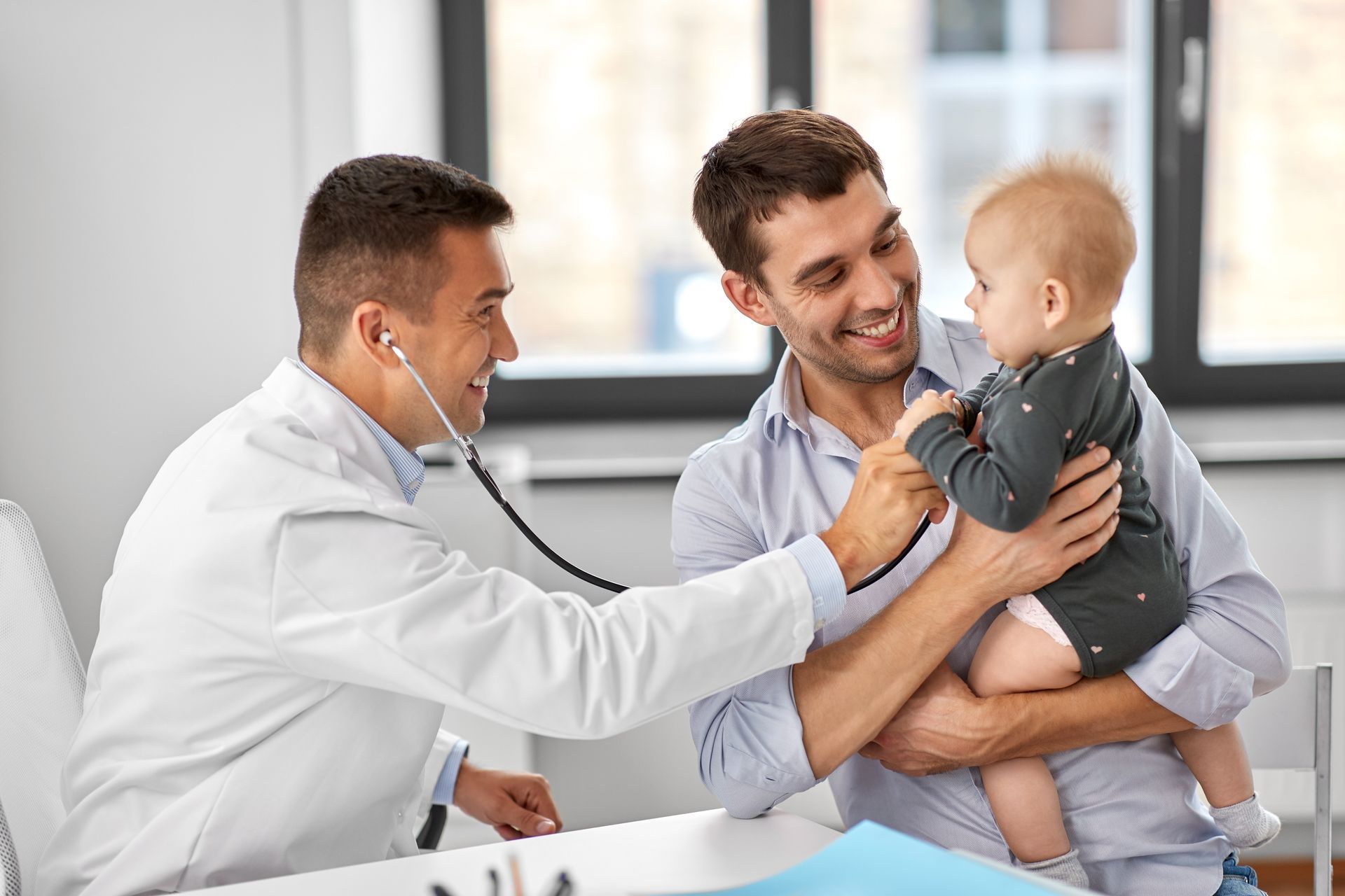 A father with a baby getting checked at the family doctor's clinic