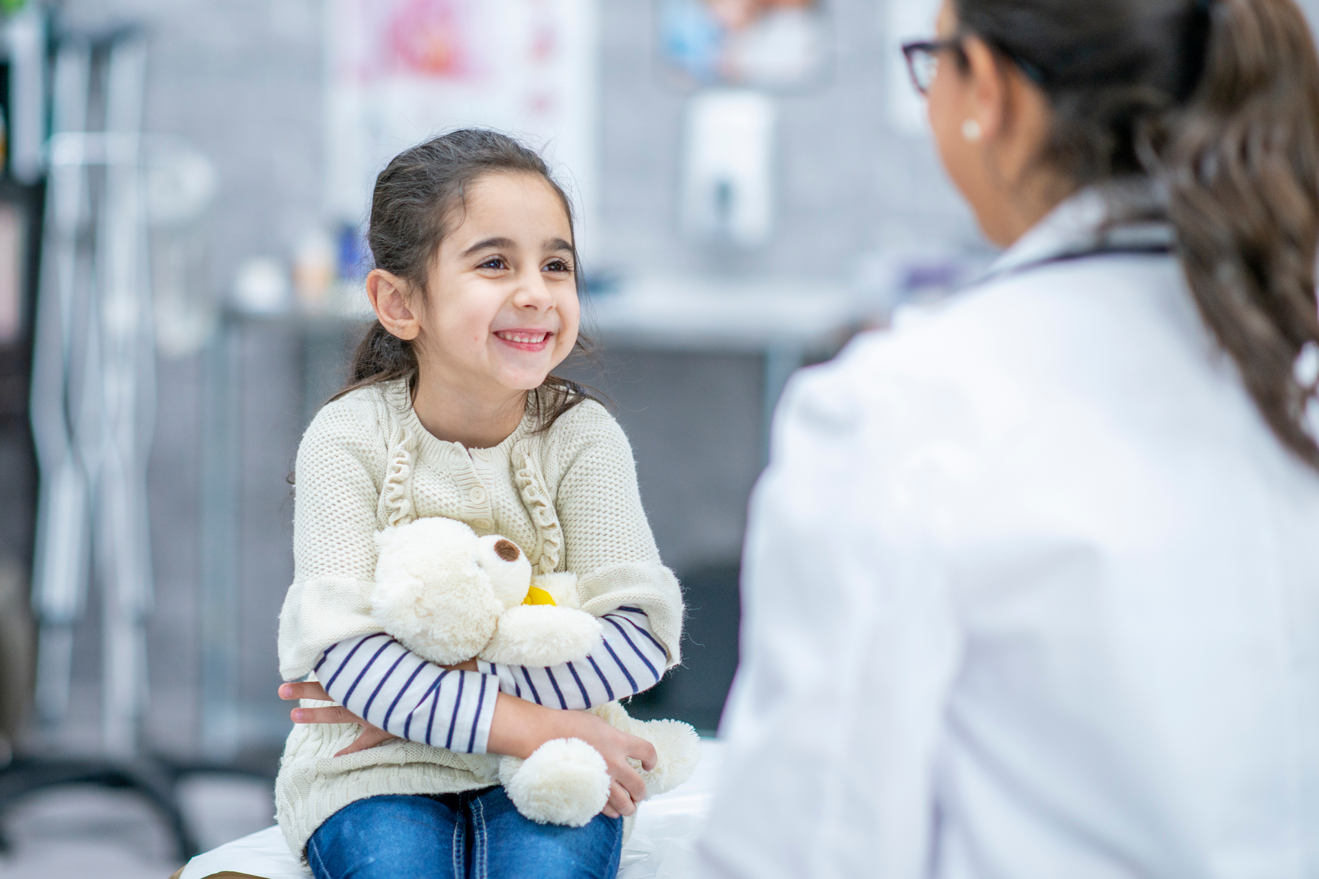 A healthy child getting checked by a doctor at a local pediatric clinic