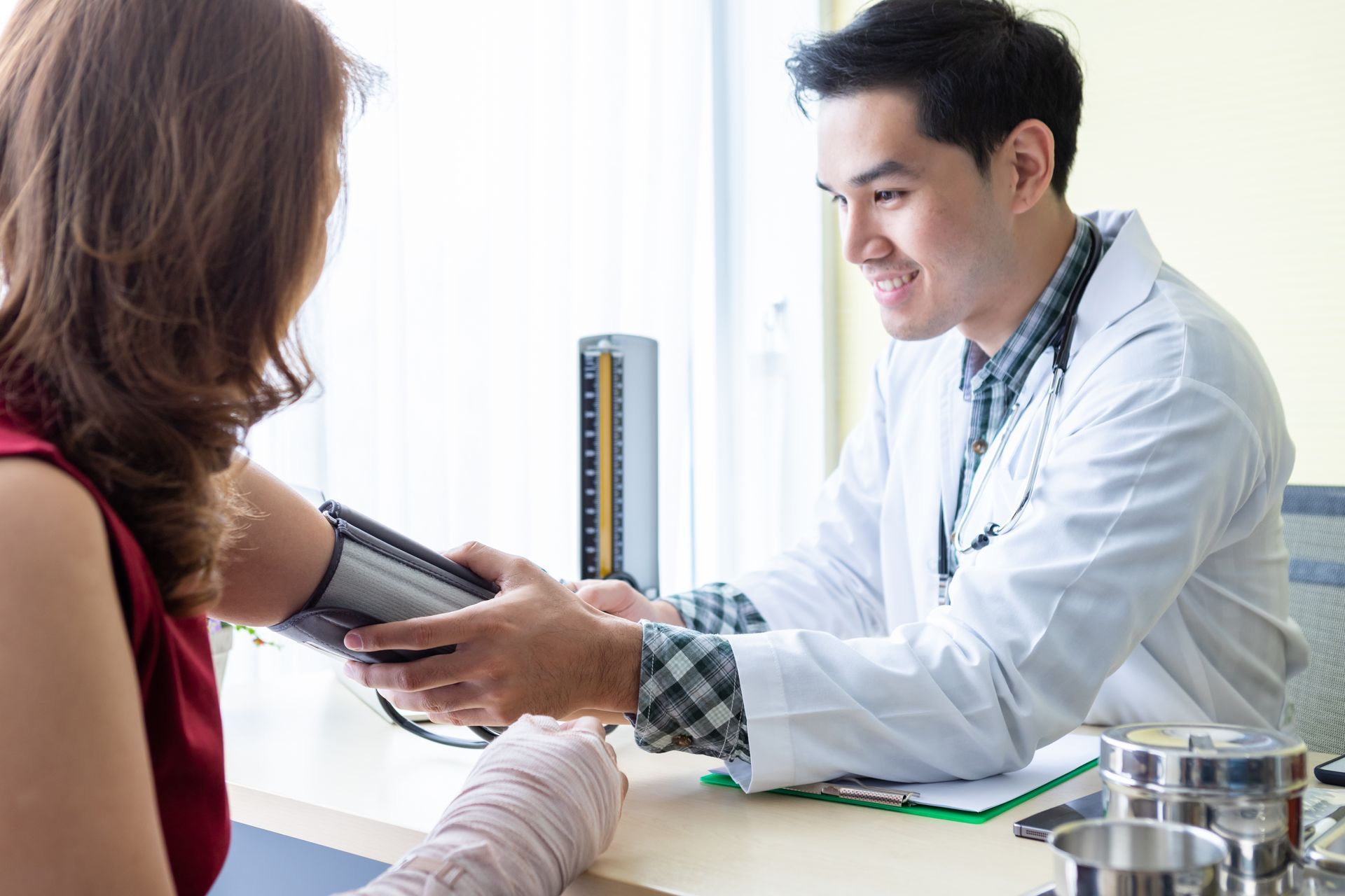 A doctor assisting his patient who is taking screening and diagnostic tests