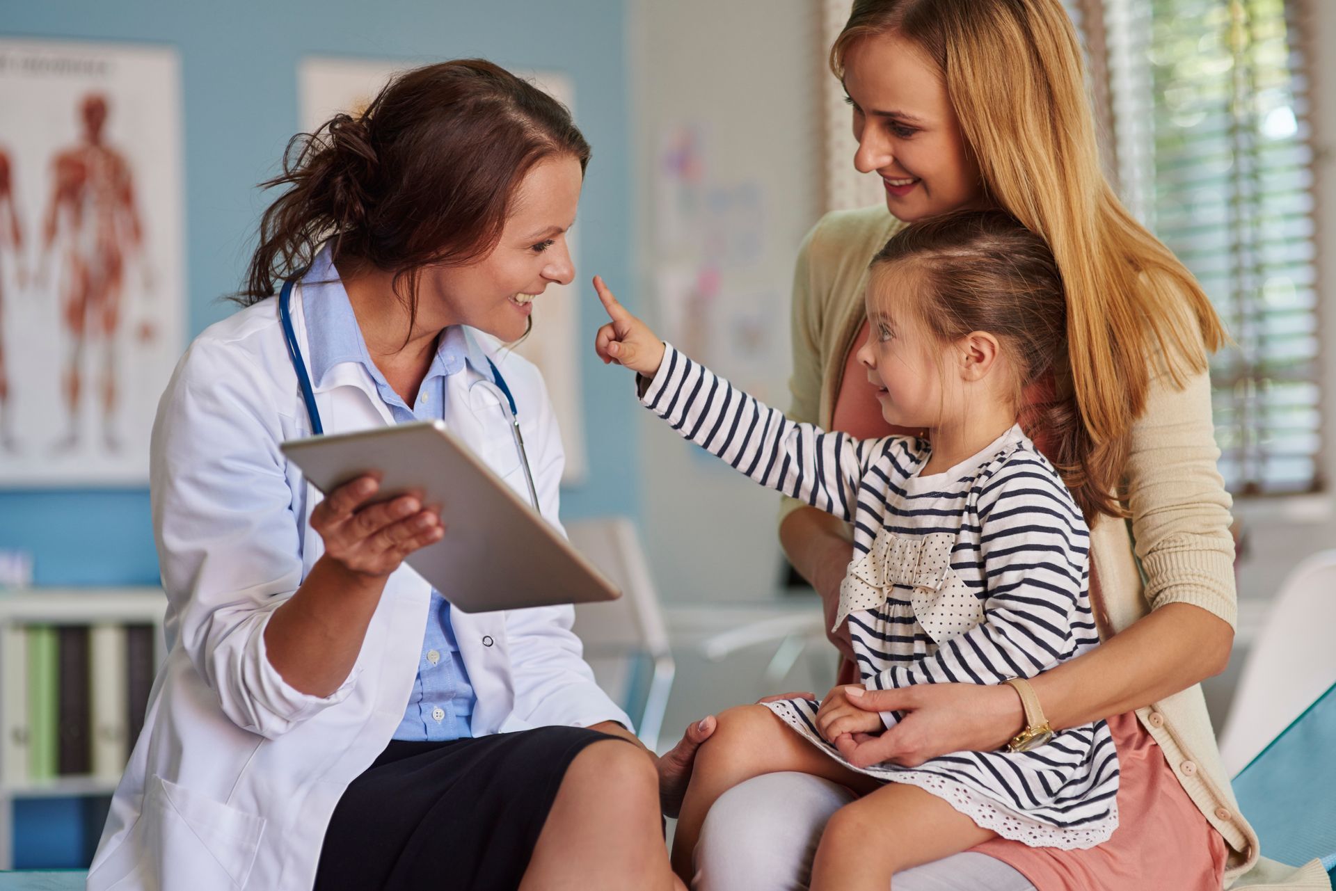 A primary care doctor bonds with her patients after their consultation. 
