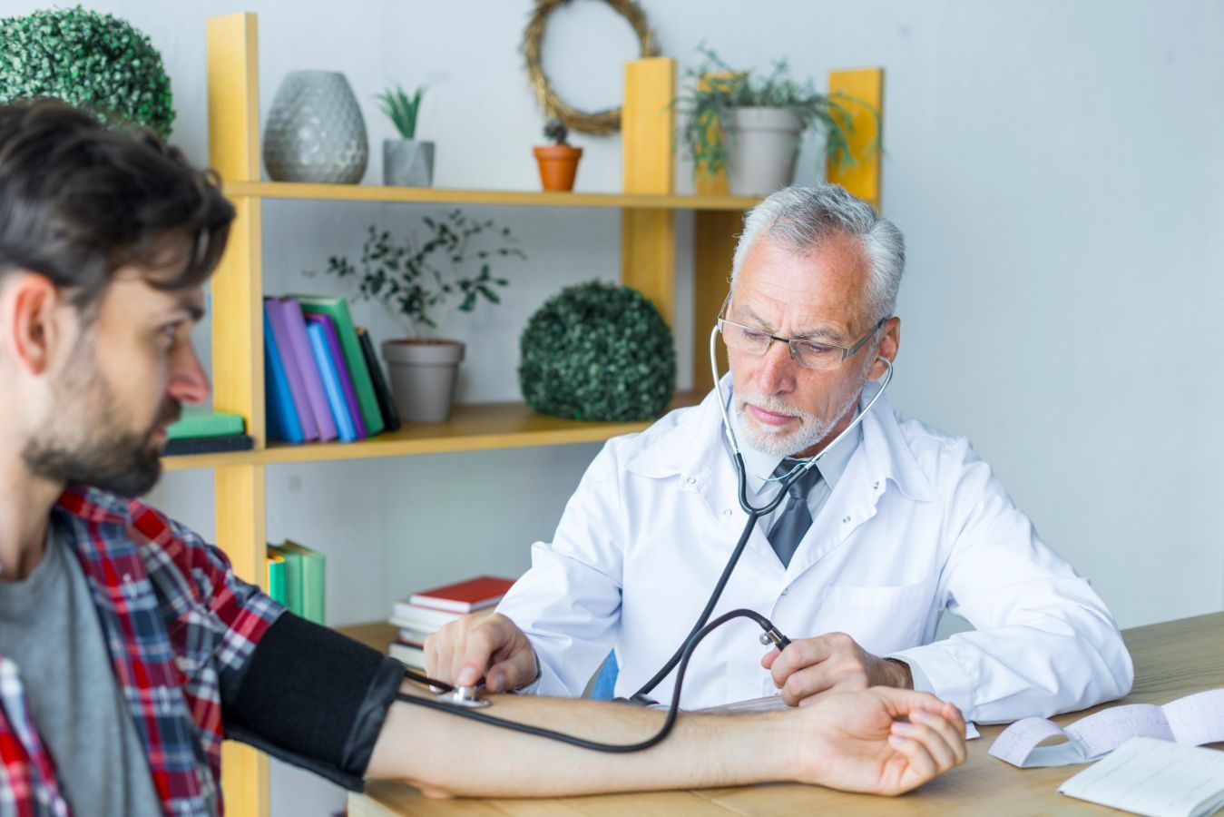 A man getting his blood pressure checked by a healthcare professional