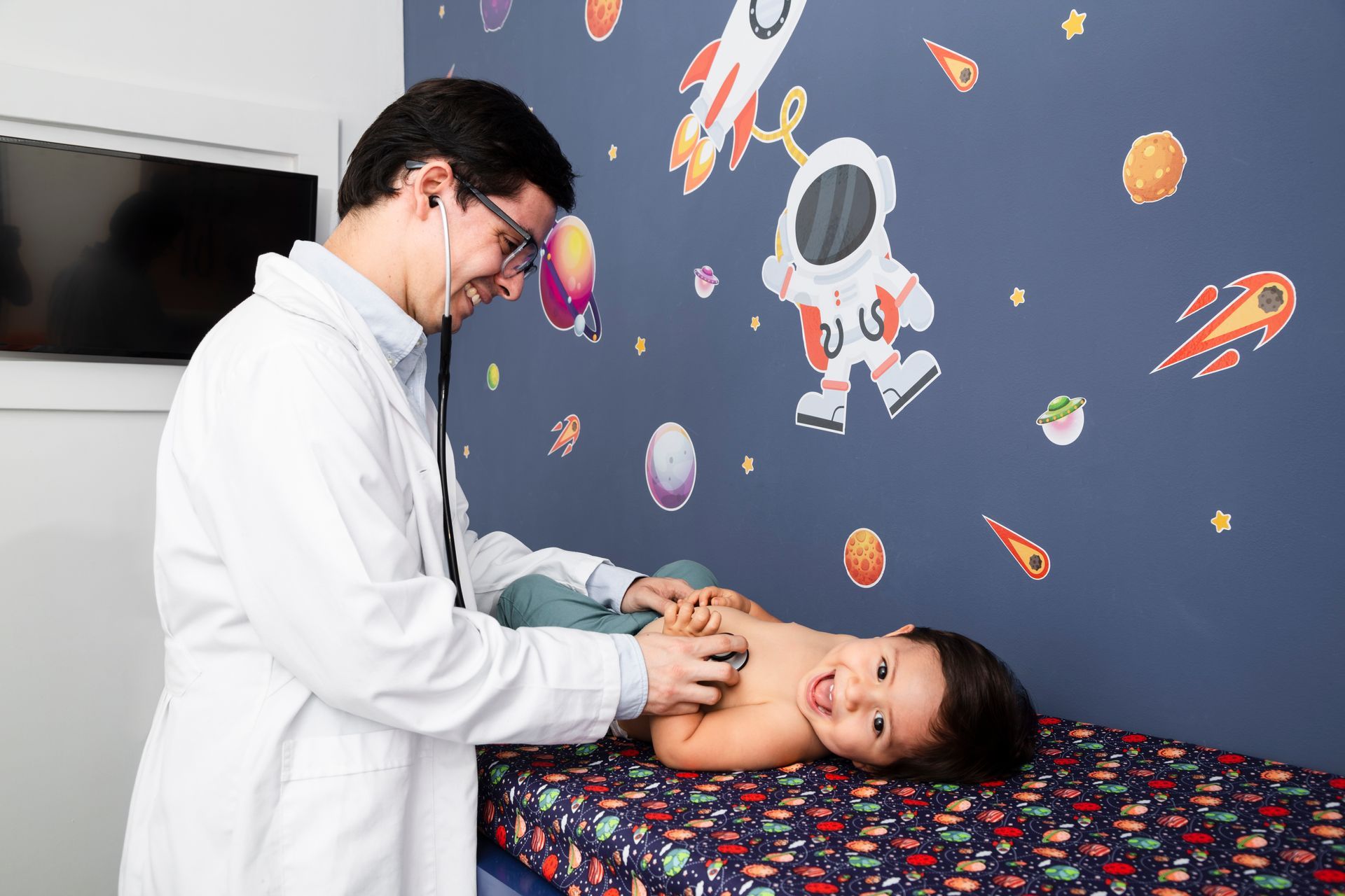 A pediatrician is checking a child’s vitals during a pediatric checkup.