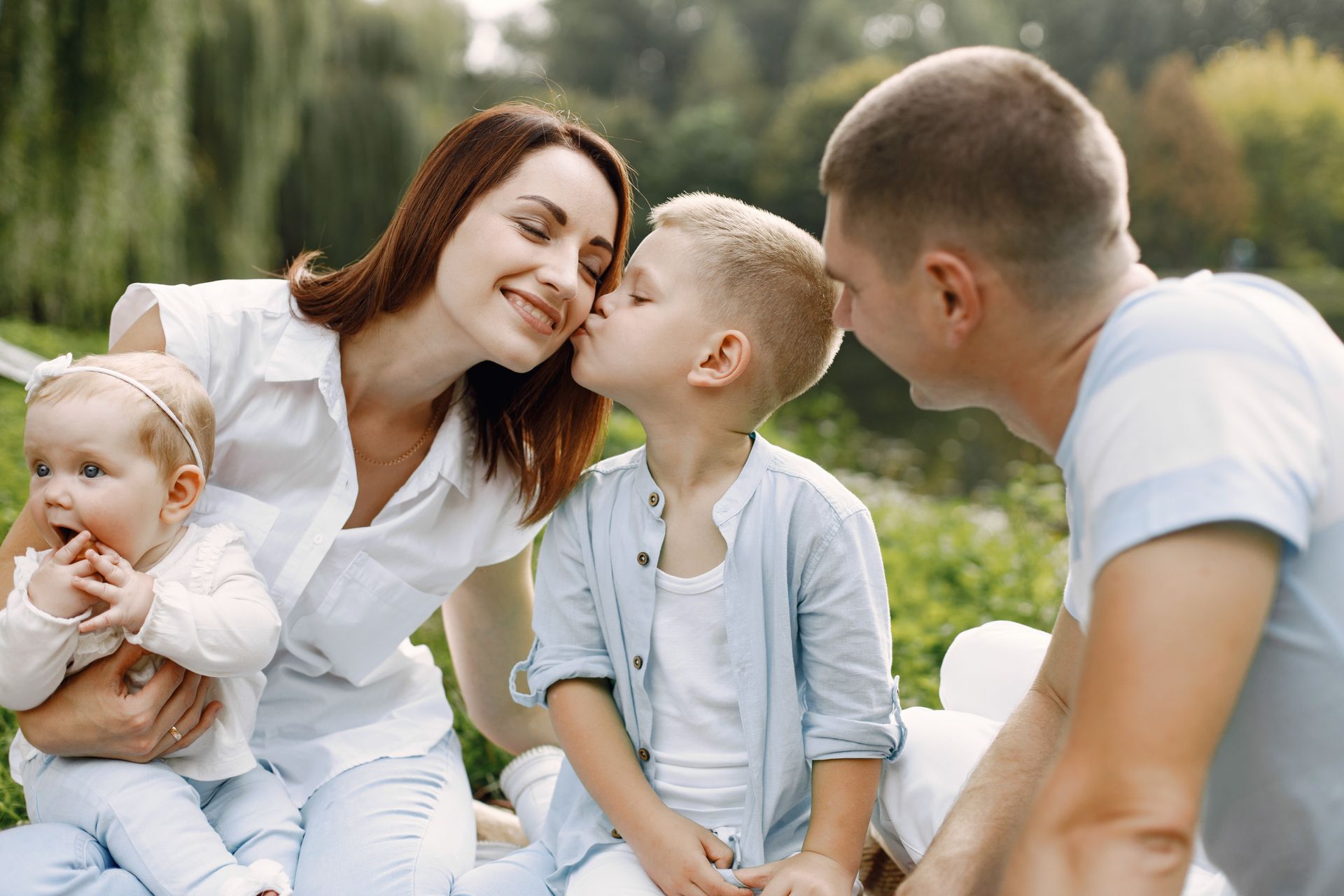 A family having a picnic at a park and feeling reassured after their preventive care  screenings.