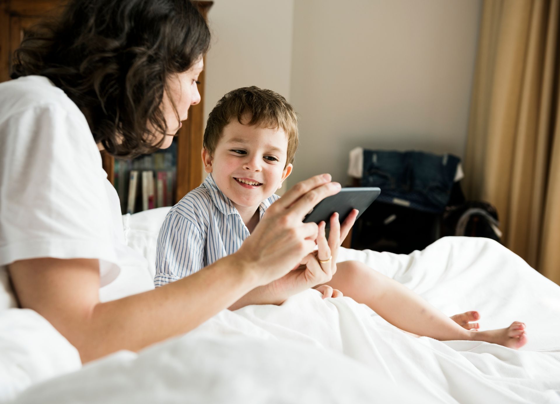 A mother guides her child toward healthy screen habits through open communication and clear boundaries.