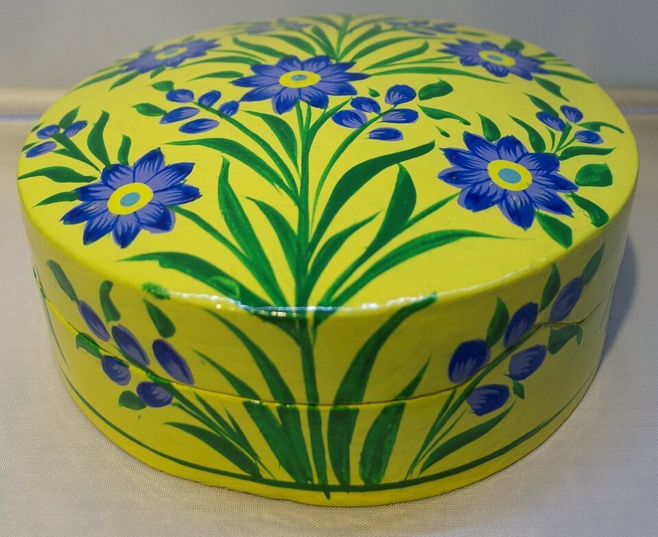 Yellow painted round box with blue flower design.