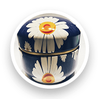 Dark blue round tin with white daisy design, gold trim.
