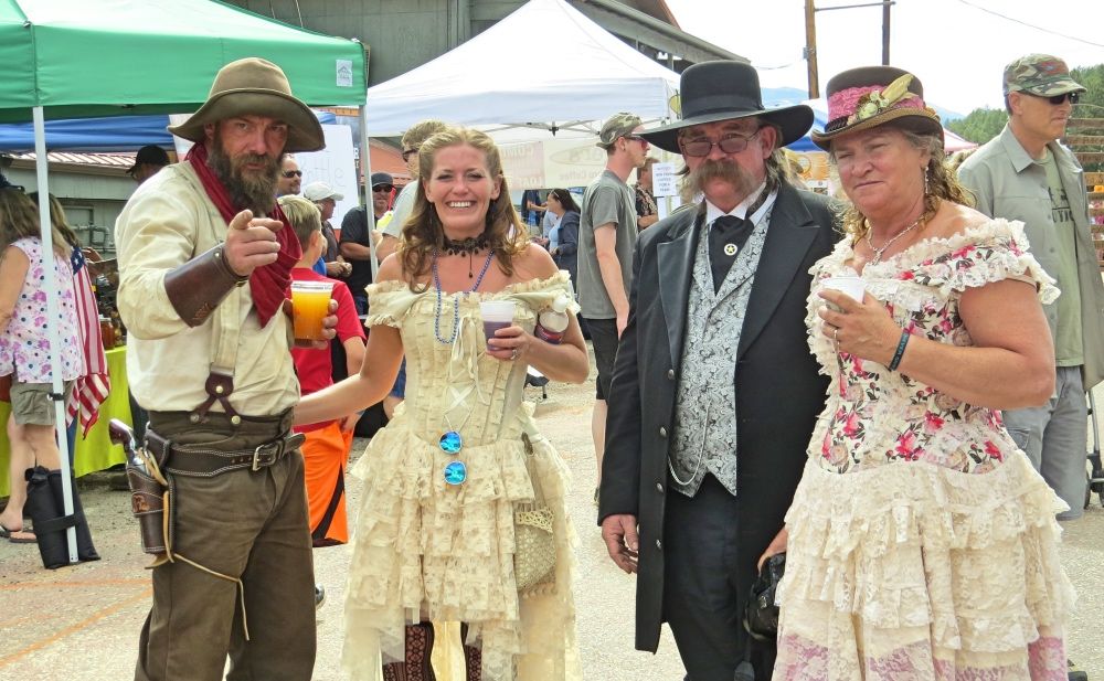 A group of people dressed in historical costumes are posing for a picture.