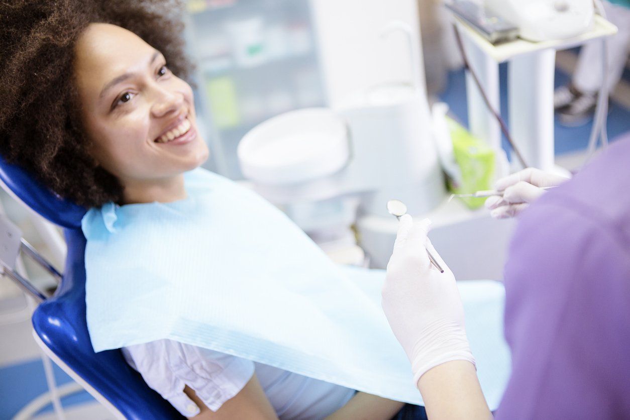 young woman smiling at dentist