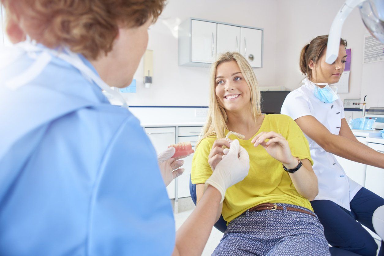 woman getting invisalign at dentist