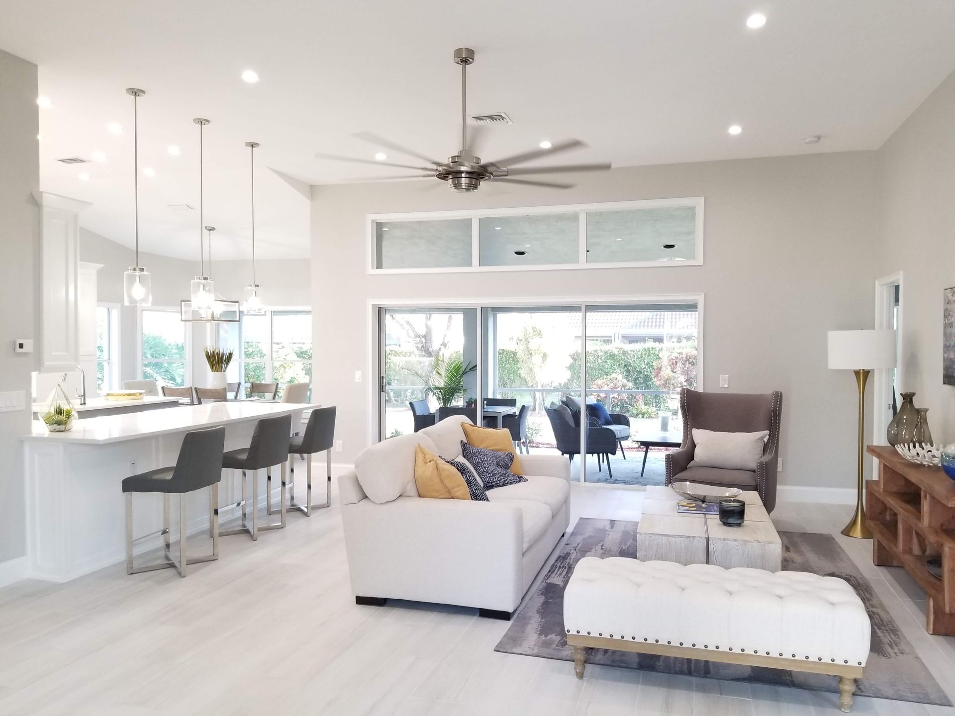A living room with a white couch and a ceiling fan